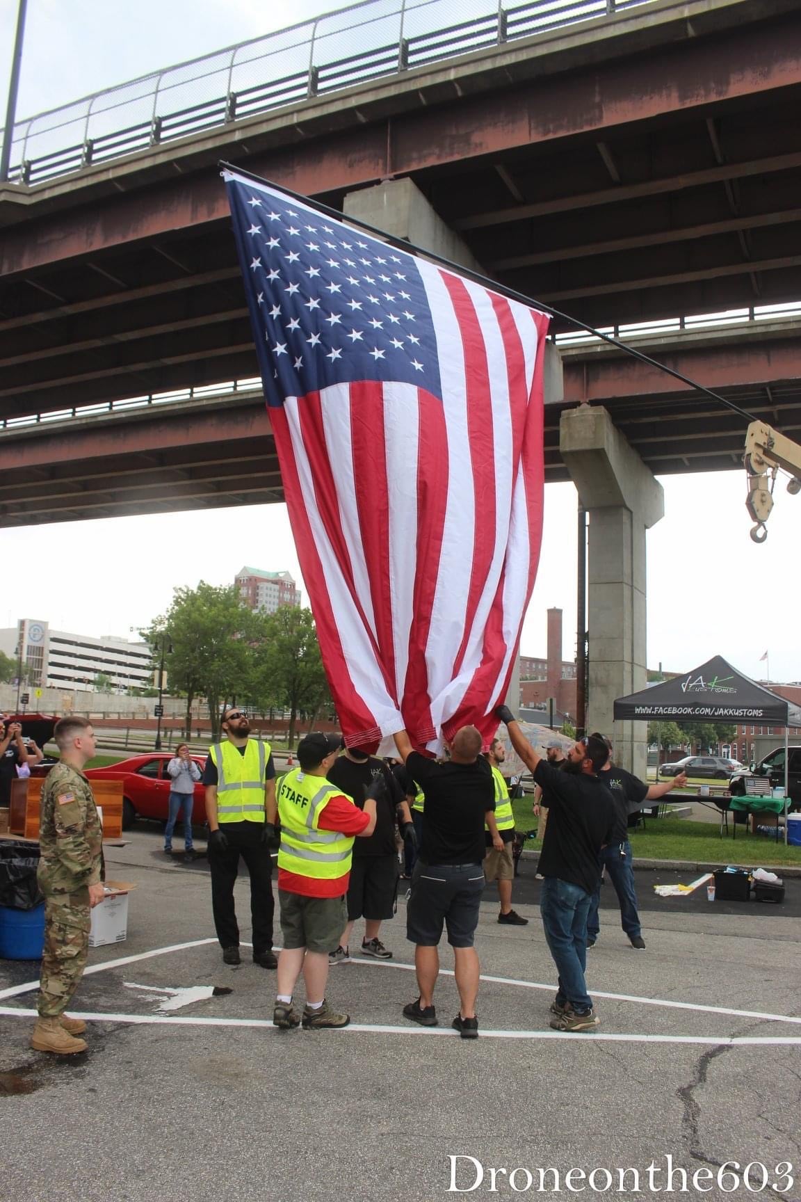 a group of people walking with a flag