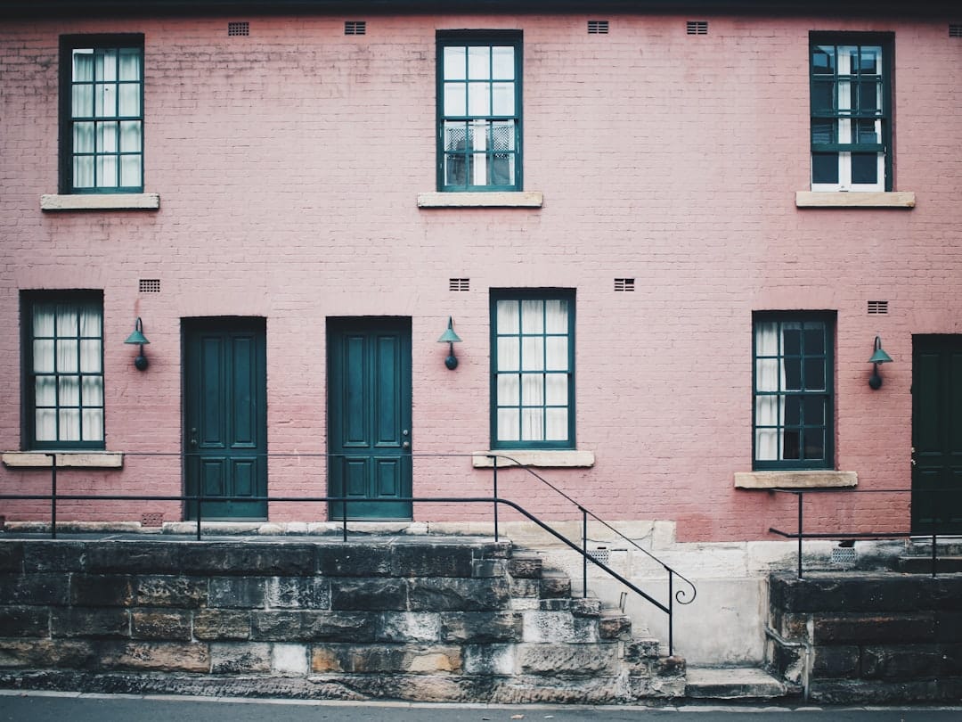 big city type townhome building with pink paint and black trim